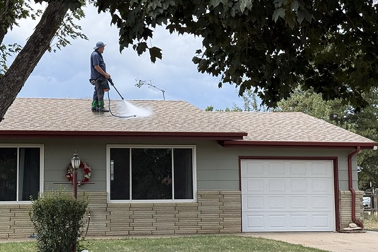 roofer spraying roof